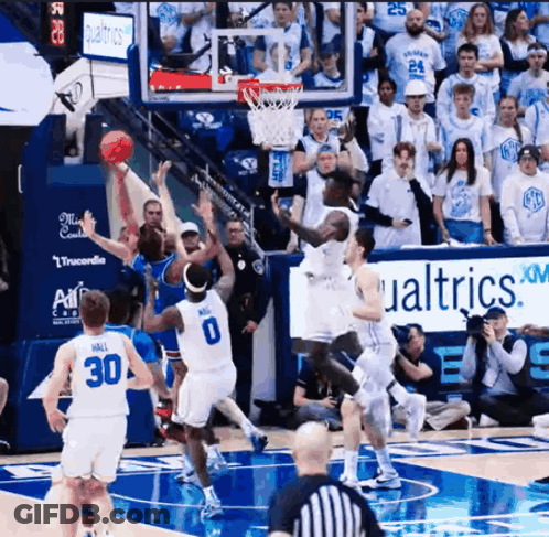 Basketball Game In Front Of Qualtrics XM Sign GIF