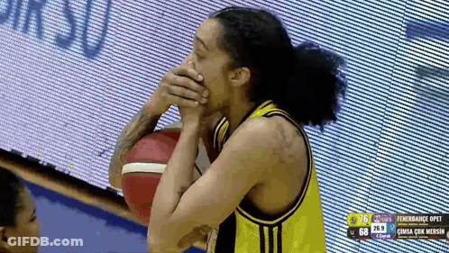 Basketball Player Covering Mouth With Hands Holding Ball GIF