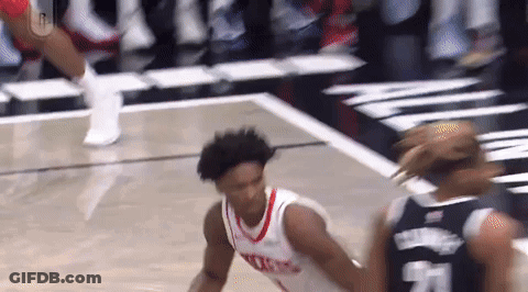 Basketball Player Dribbling Past Defender GIF