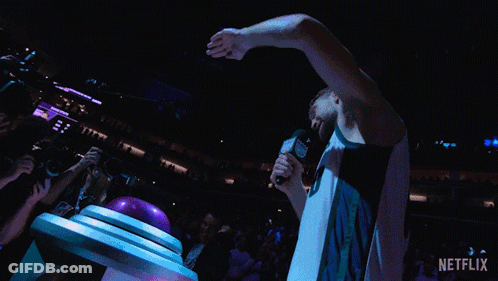 Basketball Player Holding Microphone In Crowd GIF
