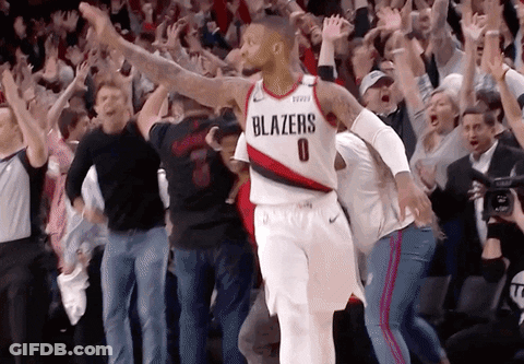 Basketball Player In Blazers Jersey Surrounded By Fans GIF