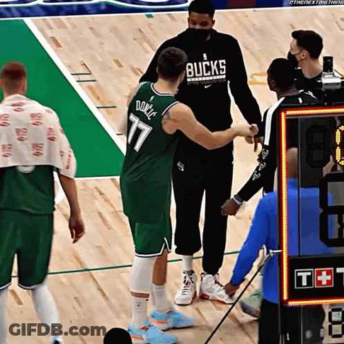 Basketball Player In Bucks Jersey Shaking Hands With Referee GIF