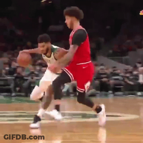Basketball Player In Green Jersey Dribbling Past Red Jersey Defender GIF