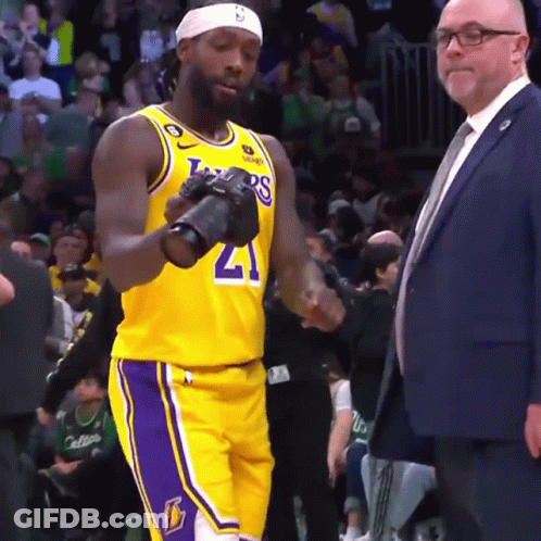 Basketball Player In Lakers Jersey Holding Camera GIF