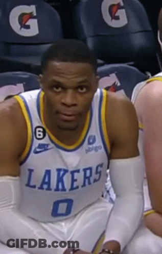 Basketball Player In Lakers Jersey Sitting On Bench GIF