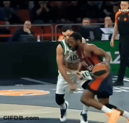 Basketball Player In Number 10 Jersey Blocking Another Player GIF