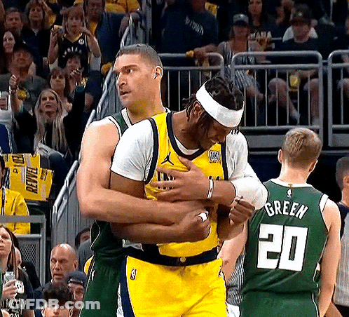Basketball Player In Number 20 Jersey Hugging Another Player GIF