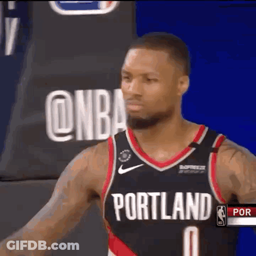 Basketball Player In Portland Jersey In Front Of NBA Logo GIF