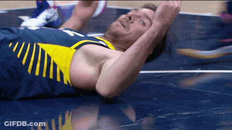 Basketball Player Laying On Floor With Arms In Air GIF