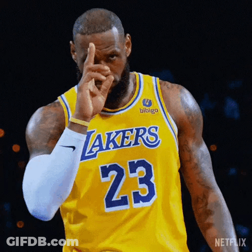 Basketball Player Lebron James Is Wearing A Yellow Lakers Jersey And Pointing At The Camera . GIF