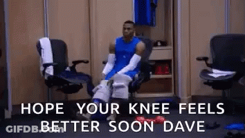 Basketball Player Sitting In Locker Room With Bandaged Knee GIF