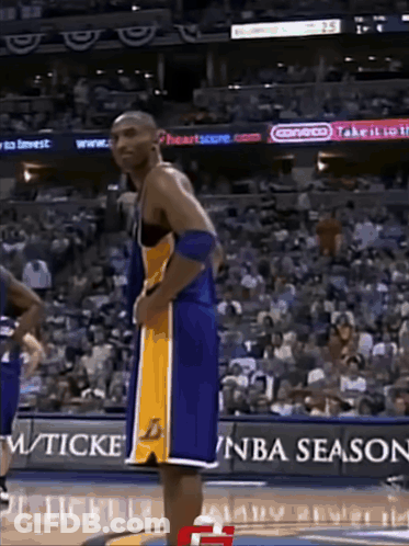 Basketball Player Standing In Front Of NBA Season Sign GIF