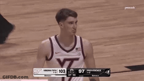 Basketball Player Standing On Court In Front Of Scoreboard GIF
