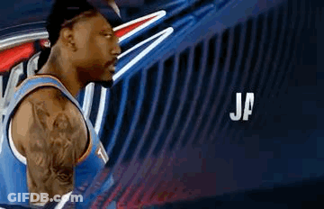 Basketball Player With Tattoo In Front Of Blue Wall GIF