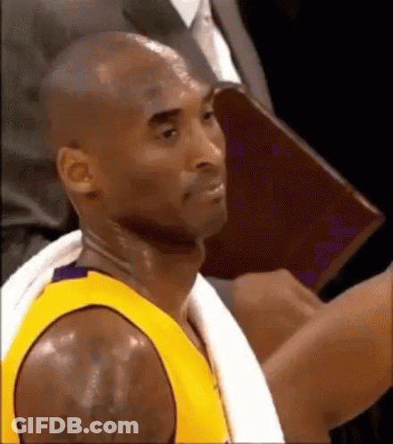 Basketball Player With Towel Sitting In Stands GIF