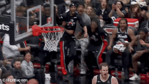 Basketball Players Celebrating Basket In Front Of Crowd GIF