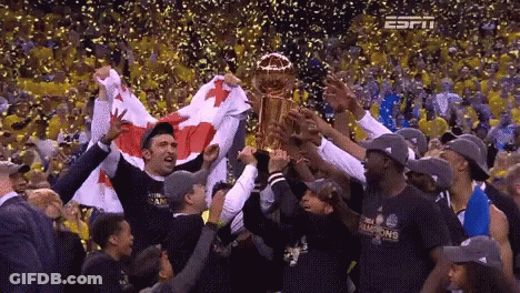 Basketball Players Holding Trophy In Crowd GIF