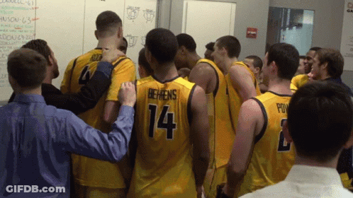 Basketball Players Huddled Including Number 14 GIF