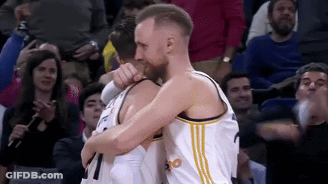Basketball Players Hugging In Front Of Crowd GIF