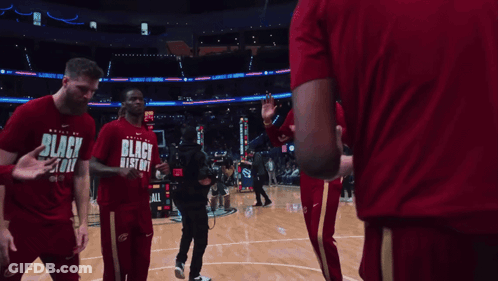 Basketball Players In Black History Shirts High Fiving GIF