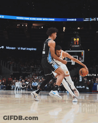 Basketball Players Near Sign Offering $20 Off Merch GIF