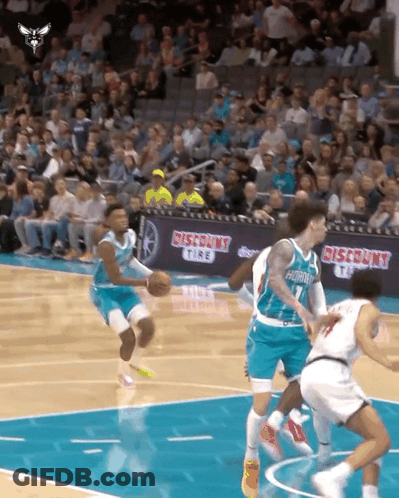 Basketball Players On A Court With A Discount Tire Banner In The Background GIF
