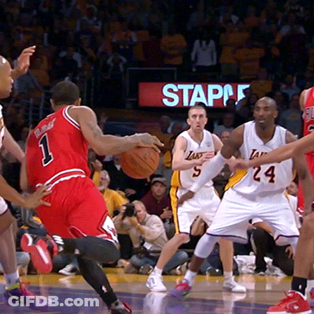 Basketball Players On A Court With A Staples Sign Behind Them GIF