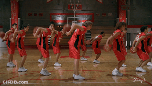 Basketball Players On Court With Disney Plus Logo GIF