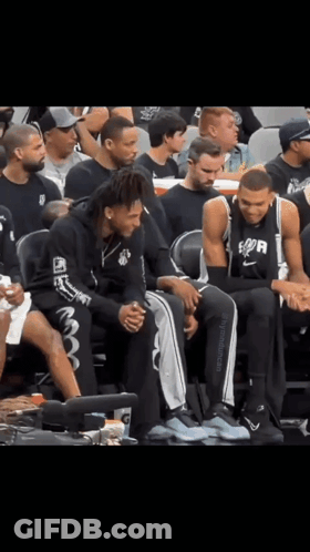 Basketball Players Sitting On Bench Spurs Shirt GIF