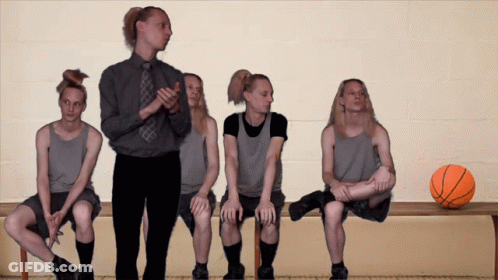 Basketball Players Sitting On Bench With Basketball GIF
