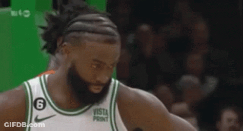 Basketball Players Standing On Green Court GIF