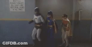 Batman And Batgirl Standing By All Lights And Door Locked Sign GIF