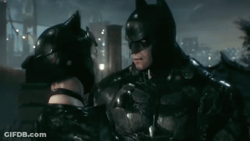 Batman And Catwoman Are Standing Next To Each Other And Looking At Each Other GIF