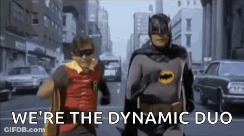 Batman And Robin Are Running Down The Street In A Dynamic Duo . GIF