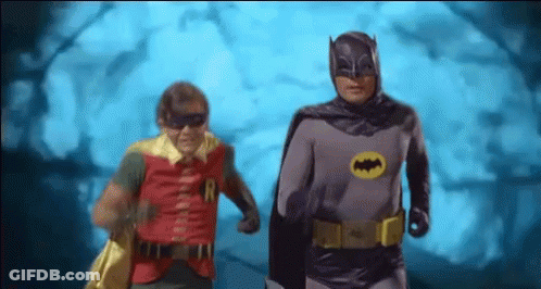 Batman And Robin Are Running In A Cave Together . GIF