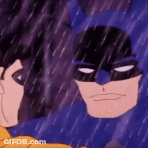 Batman And Robin Are Standing In The Rain Looking At Each Other . GIF