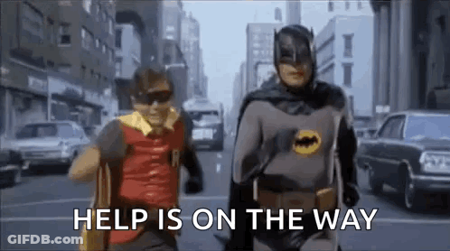 Batman And Robin Running On City Street Saying Help Is On The Way GIF