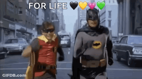 Batman And Robin Walking Down City Street With Hearts GIF