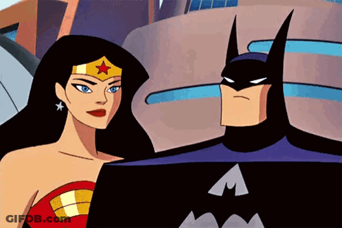 Batman And Wonder Woman Standing In Front Of Building GIF