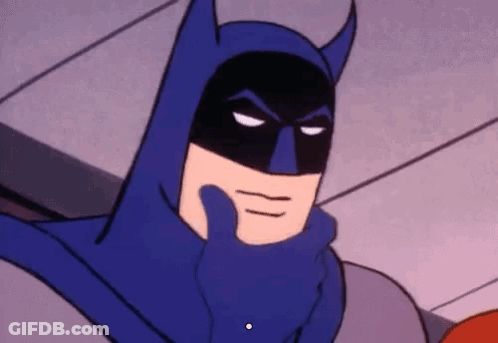 Batman In Blue Cape Holding Hand To Face GIF