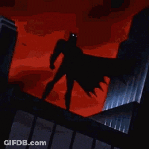 Batman Standing On Building With Blue Cape GIF