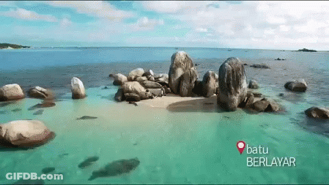 Batu Berlayar Is Written On The Bottom Of A Picture Of A Beach GIF