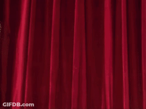 Beaker From The Muppet Show Is Holding A Chainsaw In Front Of A Red Curtain GIF
