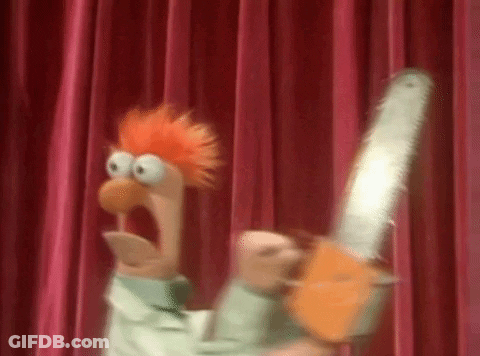 Beaker From The Muppet Show Is Holding A Chainsaw In Front Of A Red Curtain . GIF