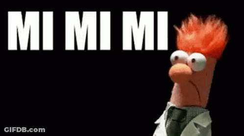 Beaker From The Muppet Show Is Standing In Front Of A Black Background With The Words `` Mi Mi Mi '' Written On It . GIF