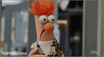 Beaker From The Muppets Is Holding A Cup Of Coffee In His Hand . GIF