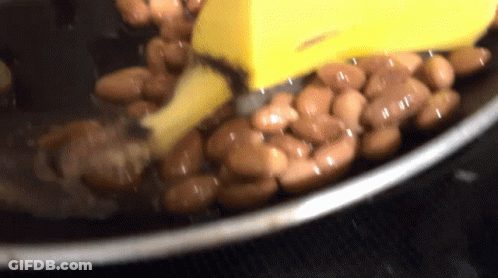 Beans Cooking In Pot With Yellow Spatula GIF