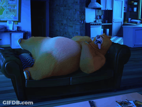 Bear Laying On Couch With Tongue Out GIF