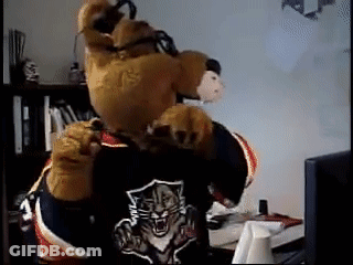 Bear Mascot Laying In Snow Feet Up GIF