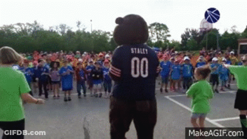 Bear Mascot With Number 00 In Front Of Children GIF